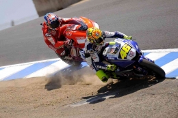 Rossi menyalip Stoner di tikungan Corkscrew. Sumber: Moto-Station.com