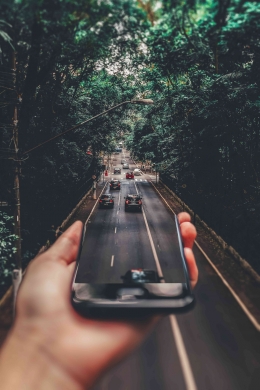 https://www.pexels.com/photo/forced-perspective-photography-of-cars-running-on-road-below-smartphone-799443/