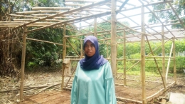 Dewi (28) warga Sukamulya berdiri di depan kerangka bambu rumahnya yang rencana ia bangun di lahan miliknya/dokpri