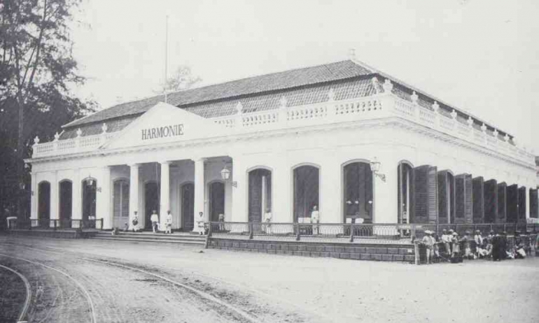 Gedung Harmonie, foto sebelum 1880. Tampak di kiri: rel trem kuda dan di kanan: warga menunggu kedatangan trem (Sumber: Woodbury & Page, hal. 54) 