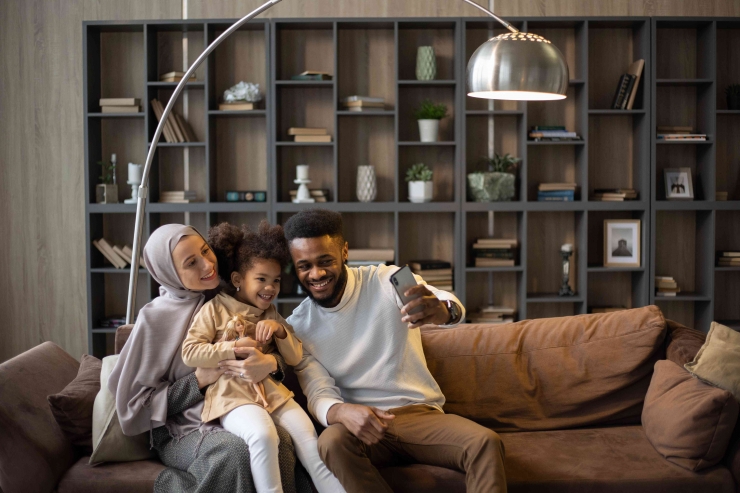 Photo by Monstera: https://www.pexels.com/photo/delighted-multiethnic-family-taking-selfie-sitting-on-couch-5996835/