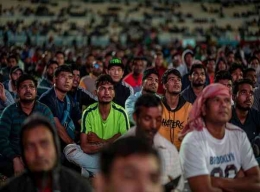 Para pekerjan migran sedang menonton pertandingan | Independent.co.uk