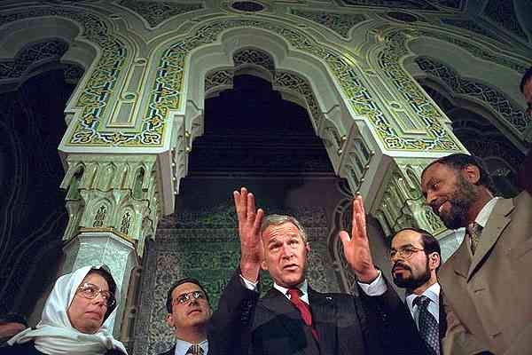 President George Bush talks with his hosts during his visit to the Islamic Center of Washington, D.C. Sept. 17, 2001, Eric Draper.