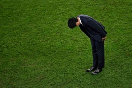 Pelatih Hajime Moriyasu membungkuk usai Jepang kalah lewat adu penalti melawan Kroasia di babak 16 besar (AFP/ANNE-CHRISTINE POUJOULA via Kompas.com)