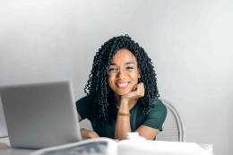 https://www.pexels.com/photo/happy-ethnic-woman-sitting-at-table-with-laptop-3769021/