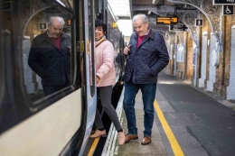 An older couple steps onto a train (linkedin.com)