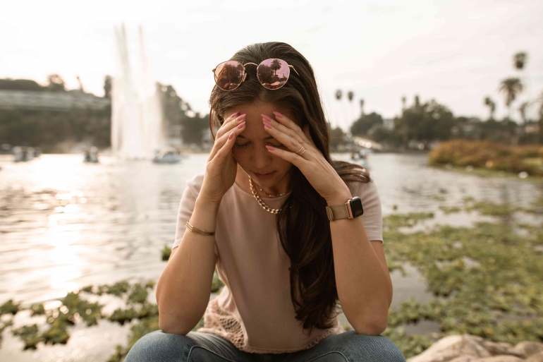 https://www.pexels.com/photo/distressed-woman-sitting-on-lakeside-and-touching-face-in-despair-5542905/