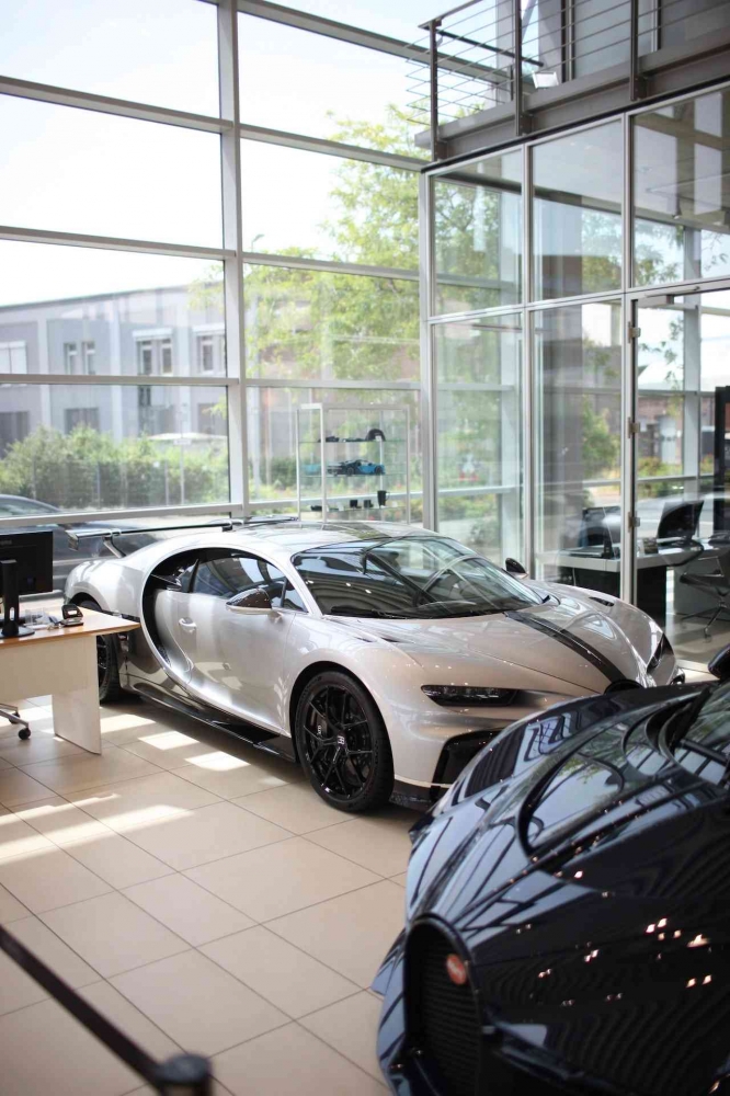 Photo by Dante Juhasz: https://www.pexels.com/photo/silver-bugatti-chiron-parked-in-front-of-glass-wall-12964186/