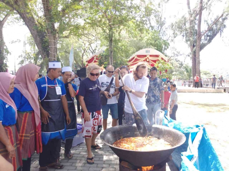 Wisatawan terlibat memasak sajian kuah Beulangong. Sumber: acehbisnis.com
