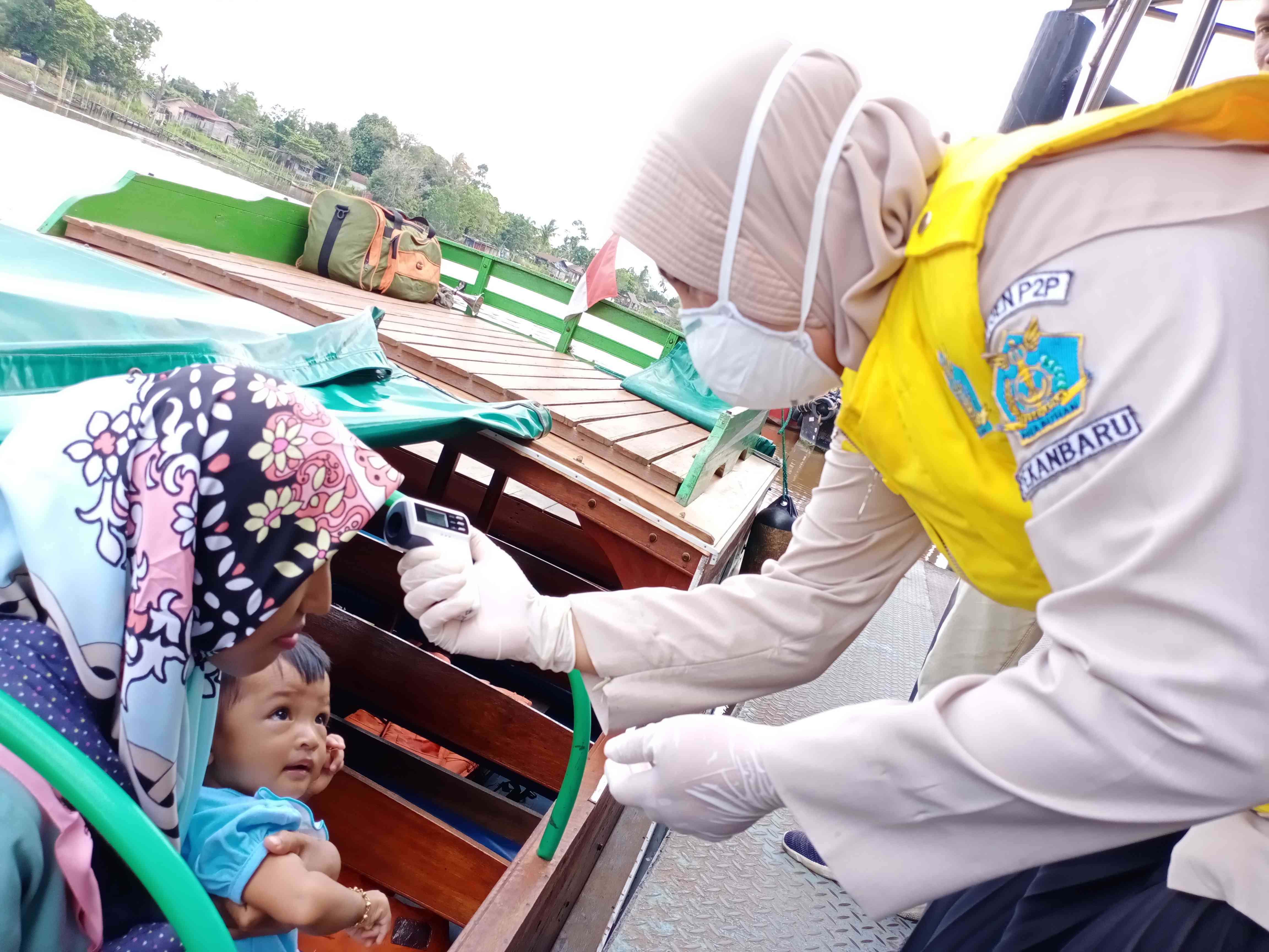 Pemeriksaan suhu tubuh oleh Petugas Klinik Pelabuhan KKP wilayah kerja Sungai Duku, Pekanbaru, pada covid-19 lalu. Foto: Sofiah.