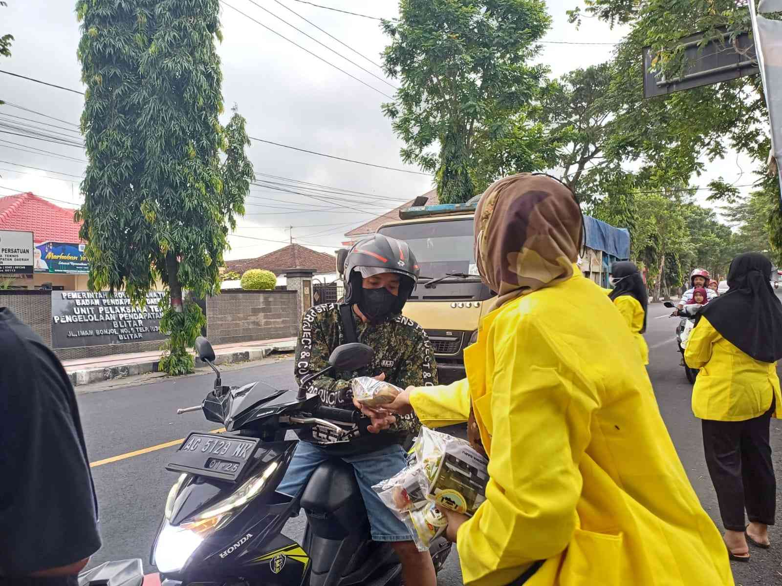 Mahasiswa Salut Blitar Raya sedang memberikan Ta'jil kepada pengendara.