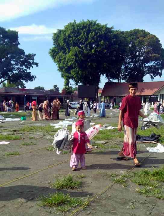 Anak kecil mengumpulkan koran sebagai alas salat Id/ Foto: Dokumentasi Pribadi