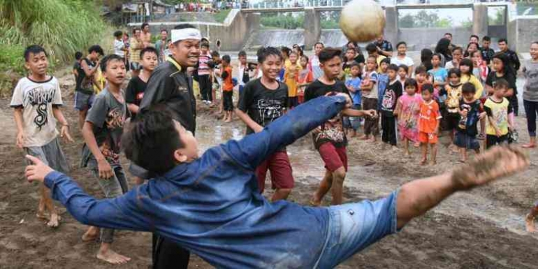 Bermain bola lumpur bersama anak-anak di pinggir sungai Desa Ciuyah, Kecamatan Waled, Kabupaten Cirebon, Minggu (9/10/2016).(KOMPAS.COM/IRWAN NUGRAHA)