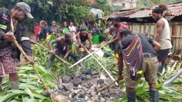 Sekelompok masyarakat Papua sedang memasak dengan cara bakar batu | Tni.mil.id