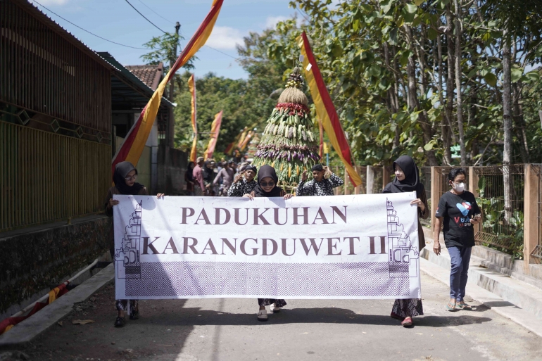 Mahasiswi KKN diberikan amanat untuk membawa banner (Dokpri)