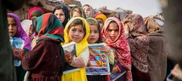 Anak-anak pengungsi Afghanistan sedang berdiri di depan sebuah sekolah di Islamabad, Pakistan. | Sumber: UNHRC/Roger Arnold