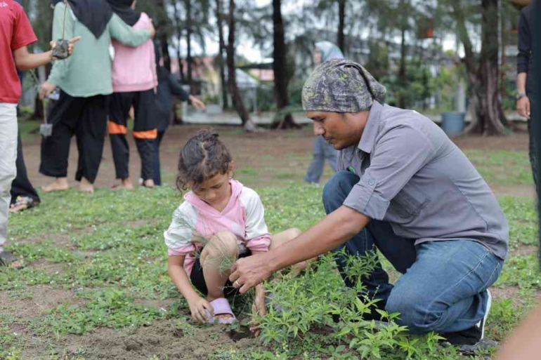 Mengajari anak bagaimana cara menanam (foto: M. Nasir)
