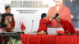 Ketum PDI Perjuangan Megawati Soekarnoputri menyematkan peci kepada calon Presiden 2024 Ganjar Pranowo, Jumat (21/4/2023). Dok. Antara Foto/Monang.