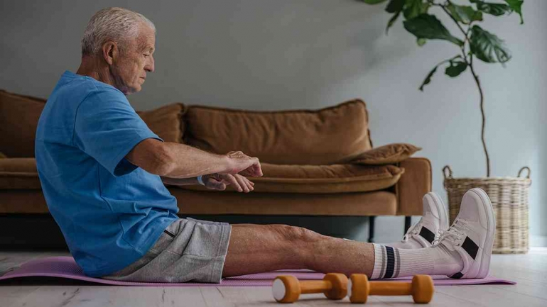 Photo by SHVETS production: https://www.pexels.com/photo/an-elderly-man-in-blue-shirt-and-gray-shorts-sitting-on-a-yoga-mat-8899515/