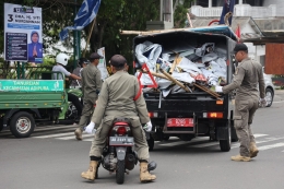Petugas Satpol PP mencopot alat peraga kampanye yang melanggar aturan di kawasan Lempuyangan, Yogyakarta, Jumat (5/1/2024). Foto: KOMPAS/FERGANATA INDRA RIATMOKO