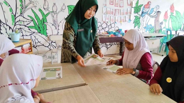 Guru di sekolah penulis sedang membagikan materi pembelajaran yang akan dipelajari di kelas (Dokpri)