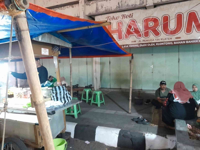 Duduk lesehan di kaki lima toko roti