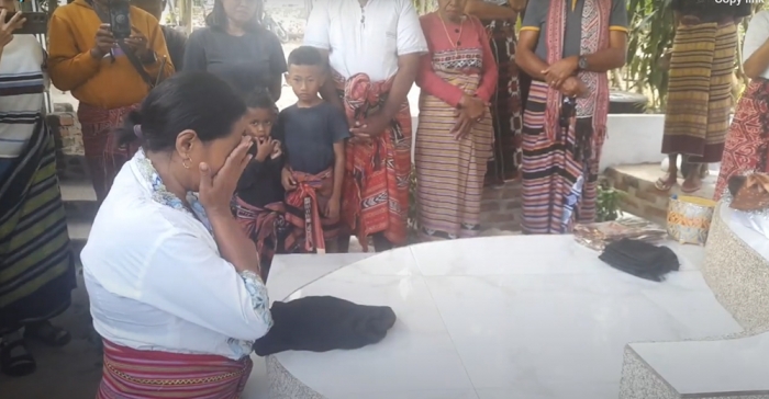 Keluarga melepaskan kain duka berwarna hitam. (Dokumentasi Channel Youtube Greg Nafanu).